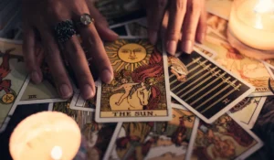 Career tarot reading spread with The Sun card and candles on a table