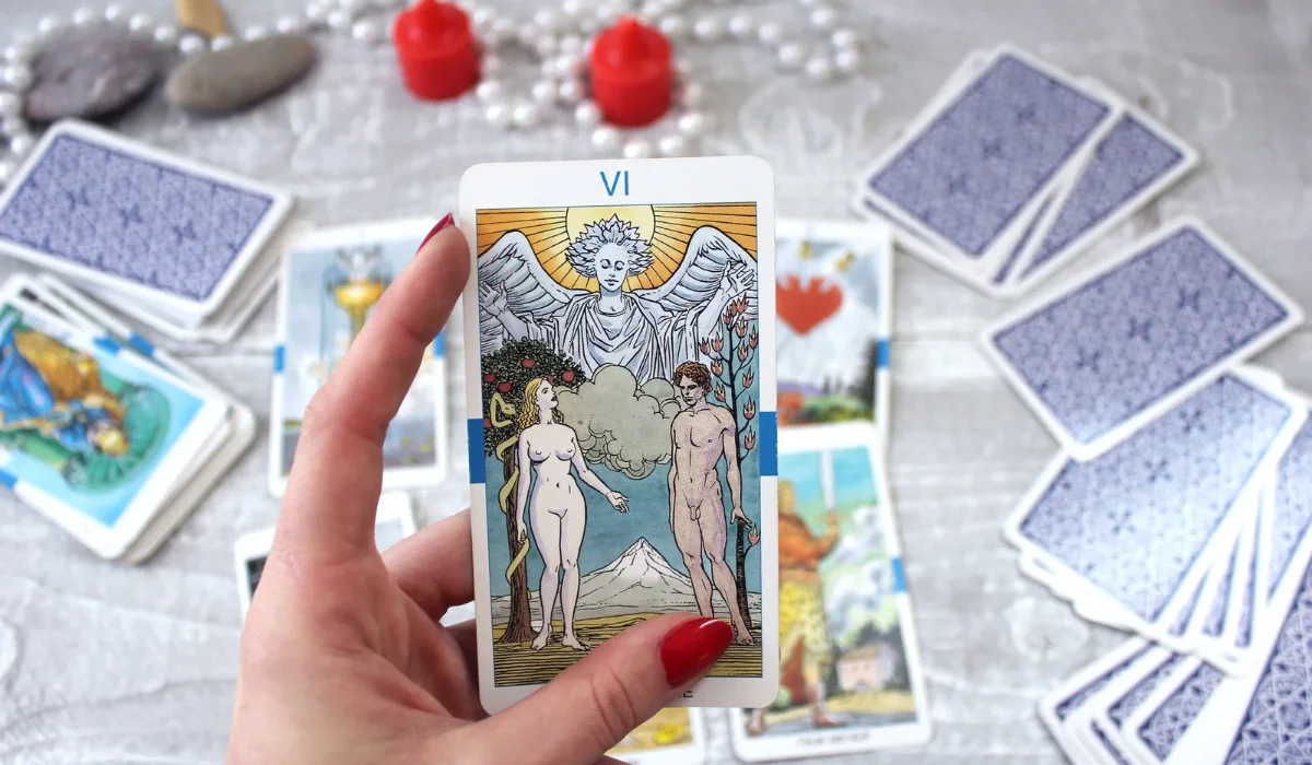 Love tarot spread laid out on a table with red candles