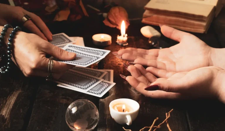 Two people at a candlelit table during a twin flame and soulmate tarot reading