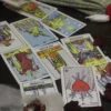 Tarot Spread for Reflection — Video Preview Tarot spread with The Star, Three of Swords and other cards beside beads and rose petals on a dark table.
